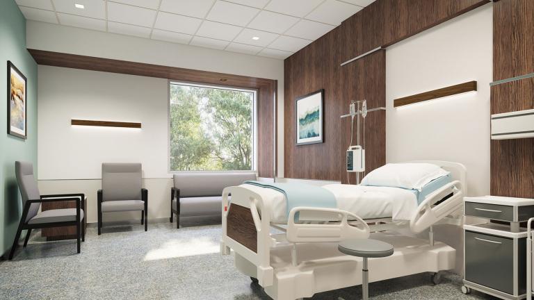 Patient room with wood wall and Walnut Seem 1 wall mount luminaires over chair and patient bed